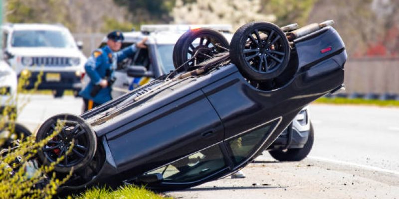 Hammonton, NJ, USA, 03/30/2024: Vehicle rollover highway road accident with police in the back